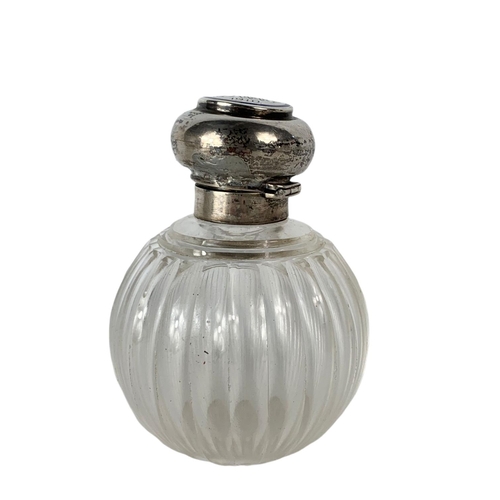 657 - Early 20th century sterling silver topped scent bottle. 13cm