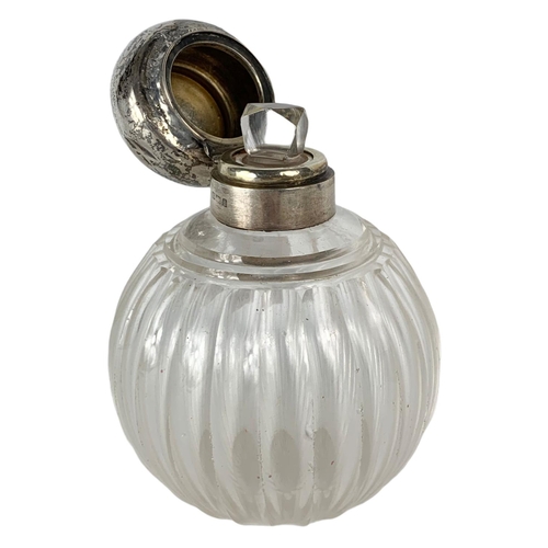 657 - Early 20th century sterling silver topped scent bottle. 13cm