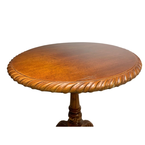 889 - Near pair of carved mahogany snap top pedestal side tables. Height of both 70cm and 66cm