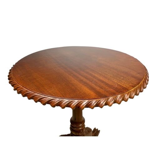 889 - Near pair of carved mahogany snap top pedestal side tables. Height of both 70cm and 66cm