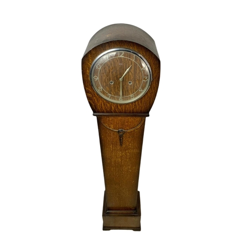 911 - 1930’s oak case granddaughter clock. 131.5cm