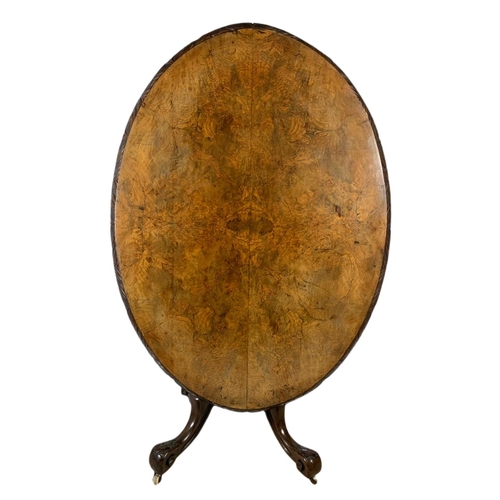 917 - Victorian carved walnut tilt top breakfast table. 138x100x73.5cm