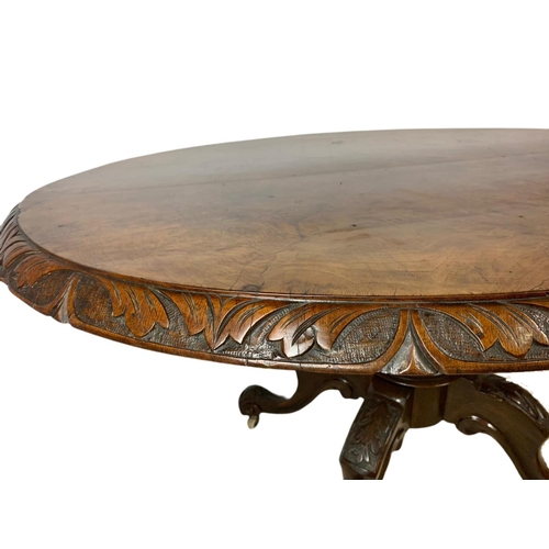 917 - Victorian carved walnut tilt top breakfast table. 138x100x73.5cm