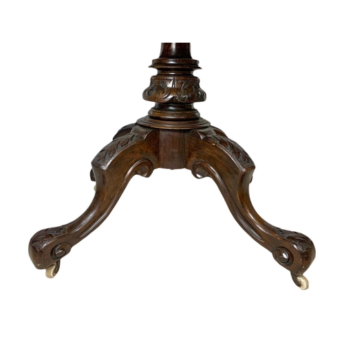 917 - Victorian carved walnut tilt top breakfast table. 138x100x73.5cm