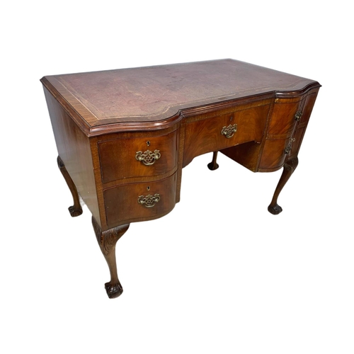 919 - 1930’s Chippendale style mahogany leather top desk with ball and claw feet. 106.5x65x77cm