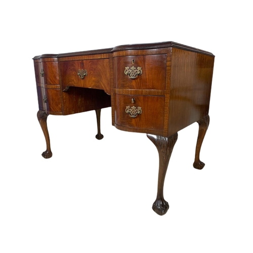 919 - 1930’s Chippendale style mahogany leather top desk with ball and claw feet. 106.5x65x77cm