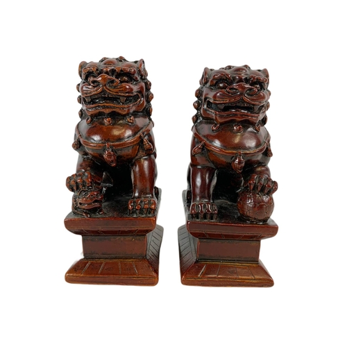 454 - Pair of small Chinese resin Foo Lions. 5/8/12cm