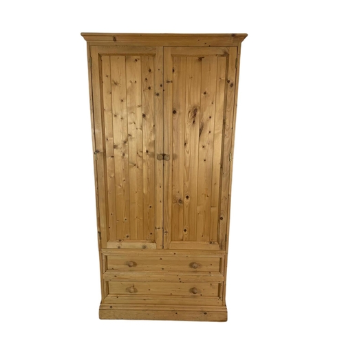 793 - 3 piece pine bedroom suite. 2 large wardrobes and a chest of drawers. Largest 84x52x206cm.