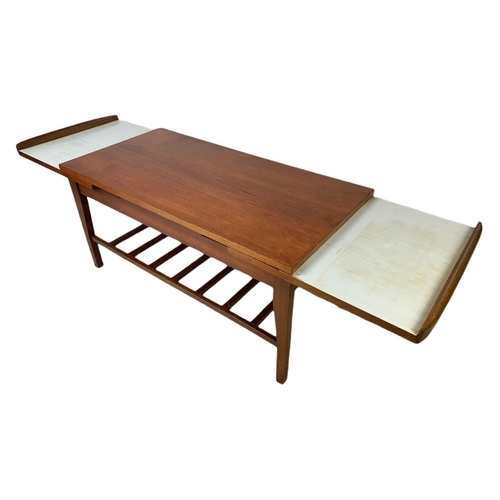 935 - Teak mid century coffee table with sliding trays. 96x46x44cm