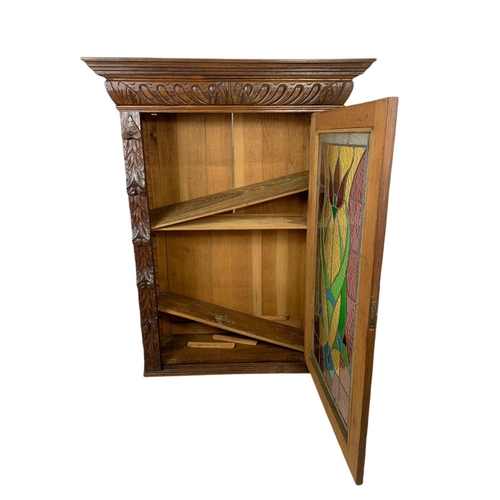 946 - Victorian carved oak wall hanging cabinet with stain glass door. 93/36/119.5cm