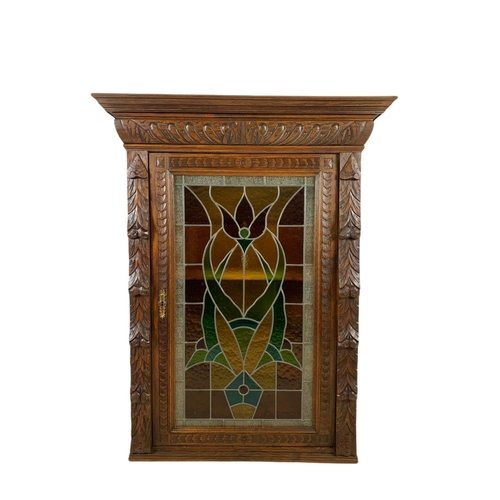 946 - Victorian carved oak wall hanging cabinet with stain glass door. 93/36/119.5cm