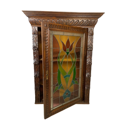 946 - Victorian carved oak wall hanging cabinet with stain glass door. 93/36/119.5cm