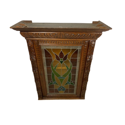 947 - Victorian carved oak wall hanging cabinet with stain glass door. 94/37/118cm