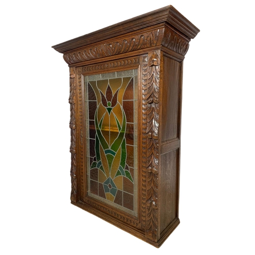 947 - Victorian carved oak wall hanging cabinet with stain glass door. 94/37/118cm