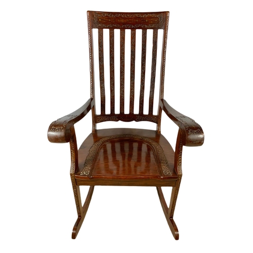 1062 - Carved Indian rosewood rocking chair with brass inlay