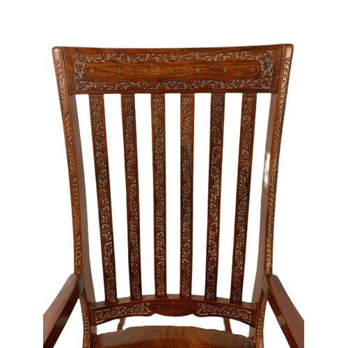 1062 - Carved Indian rosewood rocking chair with brass inlay