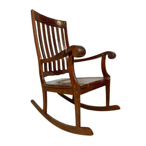 1062 - Carved Indian rosewood rocking chair with brass inlay