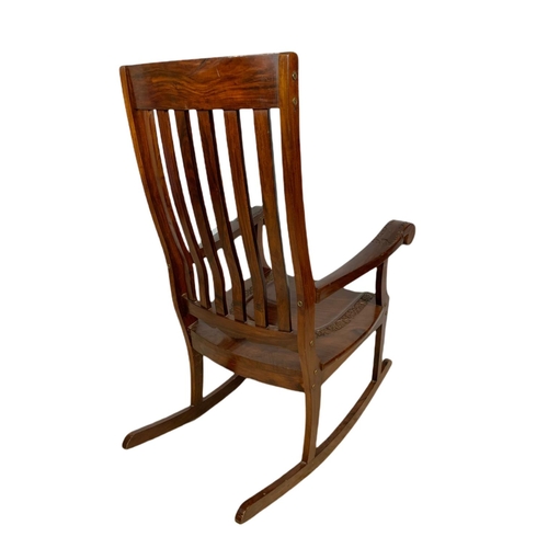 1062 - Carved Indian rosewood rocking chair with brass inlay