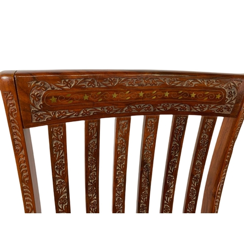 1062 - Carved Indian rosewood rocking chair with brass inlay