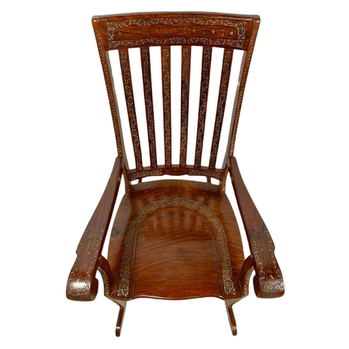 1062 - Carved Indian rosewood rocking chair with brass inlay