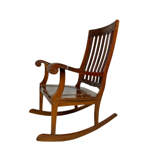 1062 - Carved Indian rosewood rocking chair with brass inlay