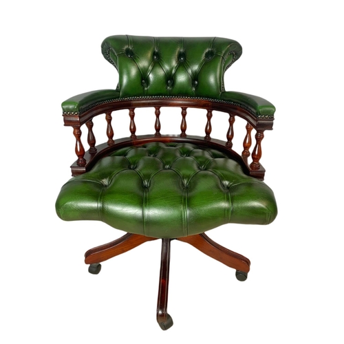 982 - Deep button leather swivel captains chair.