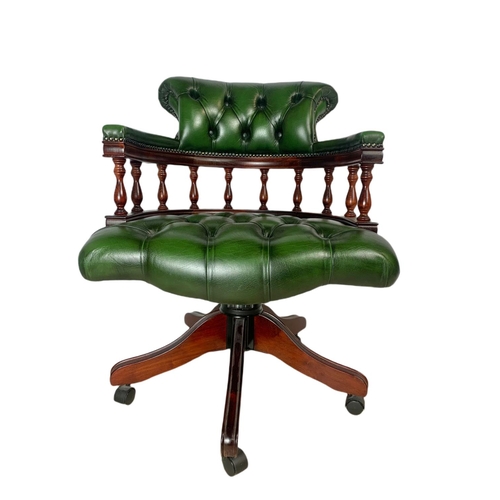 982 - Deep button leather swivel captains chair.