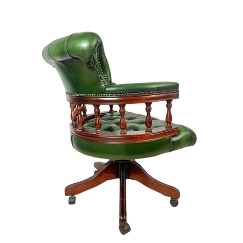 982 - Deep button leather swivel captains chair.