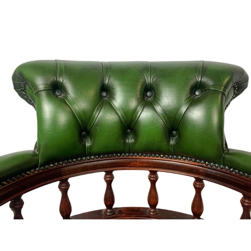 982 - Deep button leather swivel captains chair.