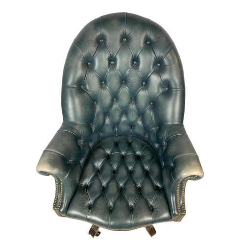 991 - High back deep button leather swivel armchair with stool. 109cm