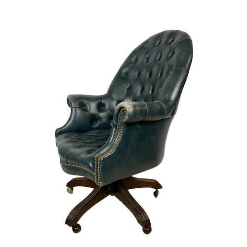 991 - High back deep button leather swivel armchair with stool. 109cm