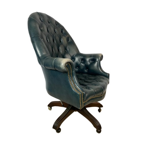 991 - High back deep button leather swivel armchair with stool. 109cm