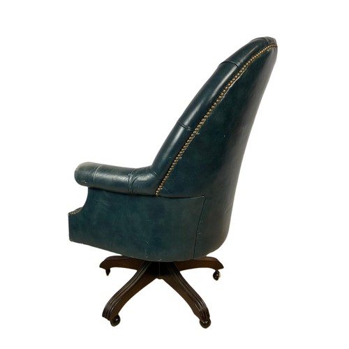 991 - High back deep button leather swivel armchair with stool. 109cm