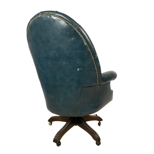 991 - High back deep button leather swivel armchair with stool. 109cm