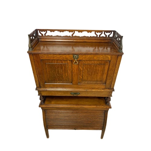 966 - Late Victorian oak fall front desk with roller shutter door compartment with brass mounts. 70x26x120... 