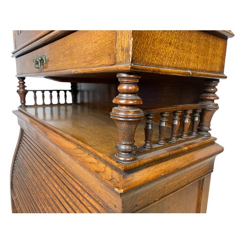 966 - Late Victorian oak fall front desk with roller shutter door compartment with brass mounts. 70x26x120... 