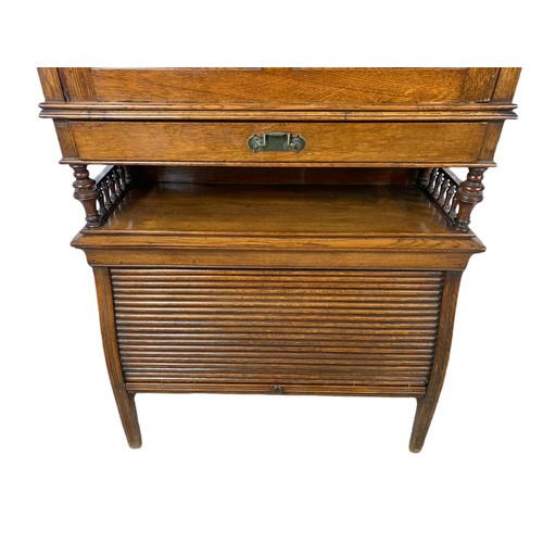 966 - Late Victorian oak fall front desk with roller shutter door compartment with brass mounts. 70x26x120... 