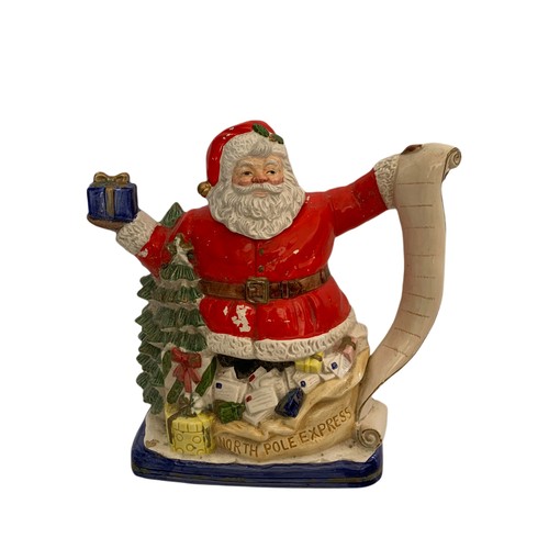 586 - Capodimonti pottery flower basket and a large pottery Santa Clause tea pot. 27/26cm