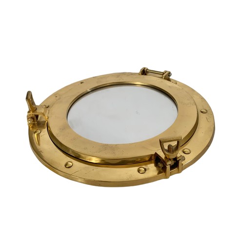 592 - Brass port hole style mirror. 29cm