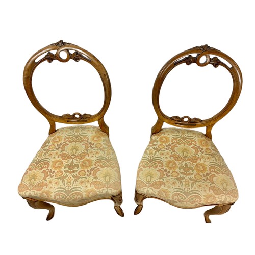 1077 - Pair of Victorian walnut balloon back side chairs.