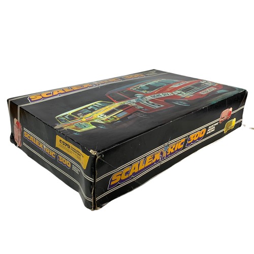 9 - Scalextic 300 electric model racing in box. Box measures 63/40/15cm