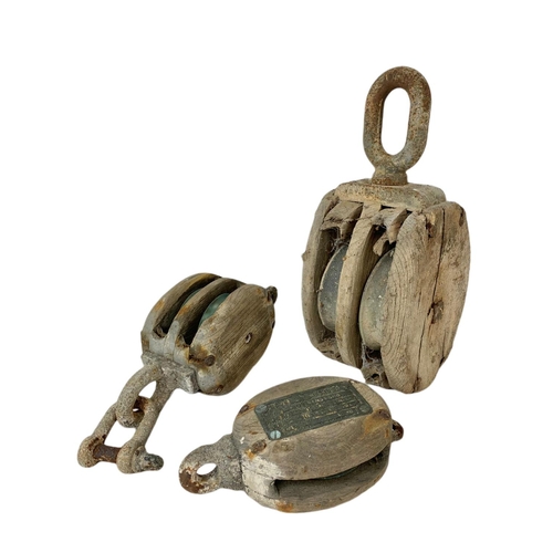 86 - 3 early 20th century pulleys. Largest 35cm