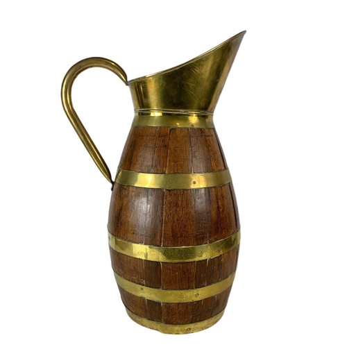 99 - Large Edwardian oak brass bound jug. 63cm