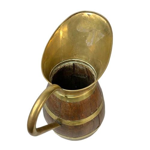 99 - Large Edwardian oak brass bound jug. 63cm