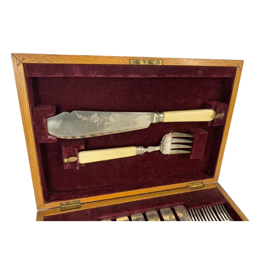 105 - Vintage silver mounted cutlery set in an oak case. 35 x 25 x 7cm