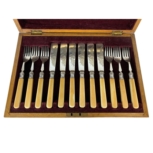 105 - Vintage silver mounted cutlery set in an oak case. 35 x 25 x 7cm