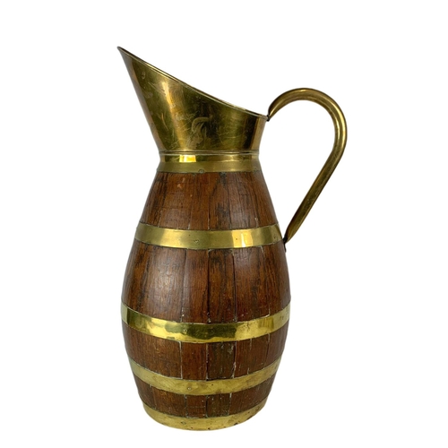 99 - Large Edwardian oak brass bound jug. 63cm