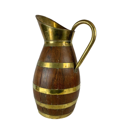 99 - Large Edwardian oak brass bound jug. 63cm