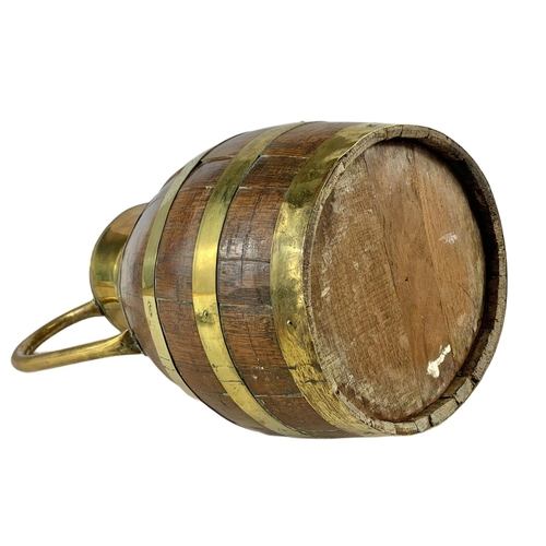 99 - Large Edwardian oak brass bound jug. 63cm