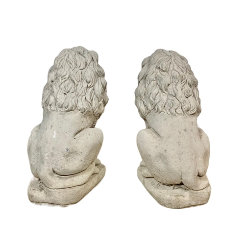 121 - Pair of concrete garden lions. 33 x 59cm